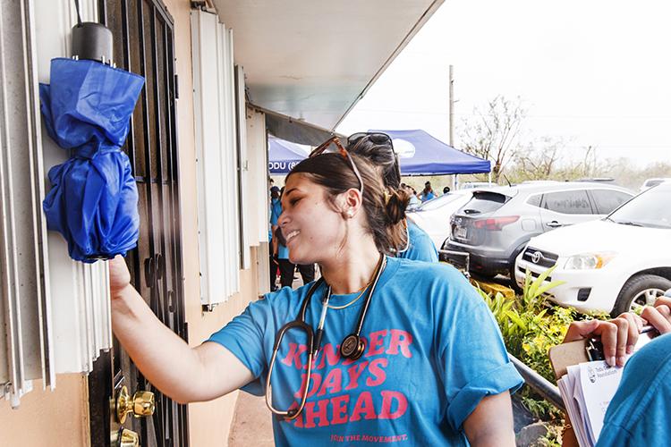 Volunteer doctors and nurses with the Todu Guam Foundation knocking on a door to check up if anyone needs assistance. 