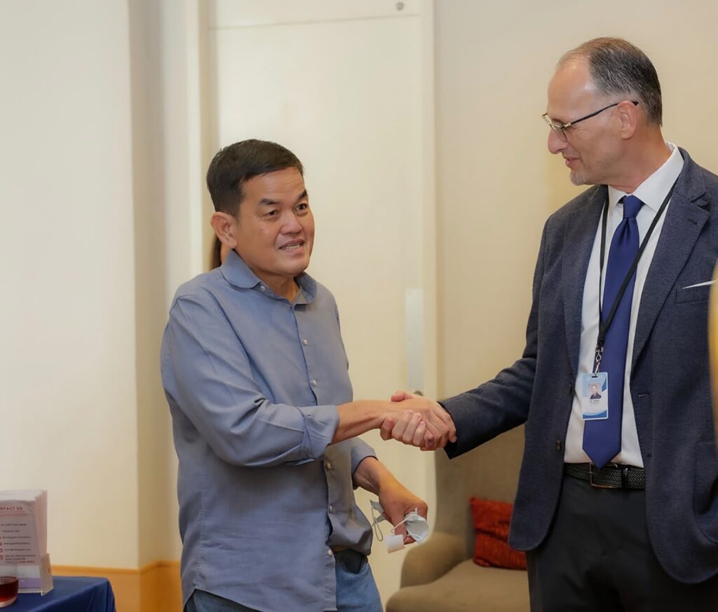 Todu Guam Foundation Medical Director Dr. Danny McClure shaking hands with internal medicine physician Dr. Leopoldo Arcilla