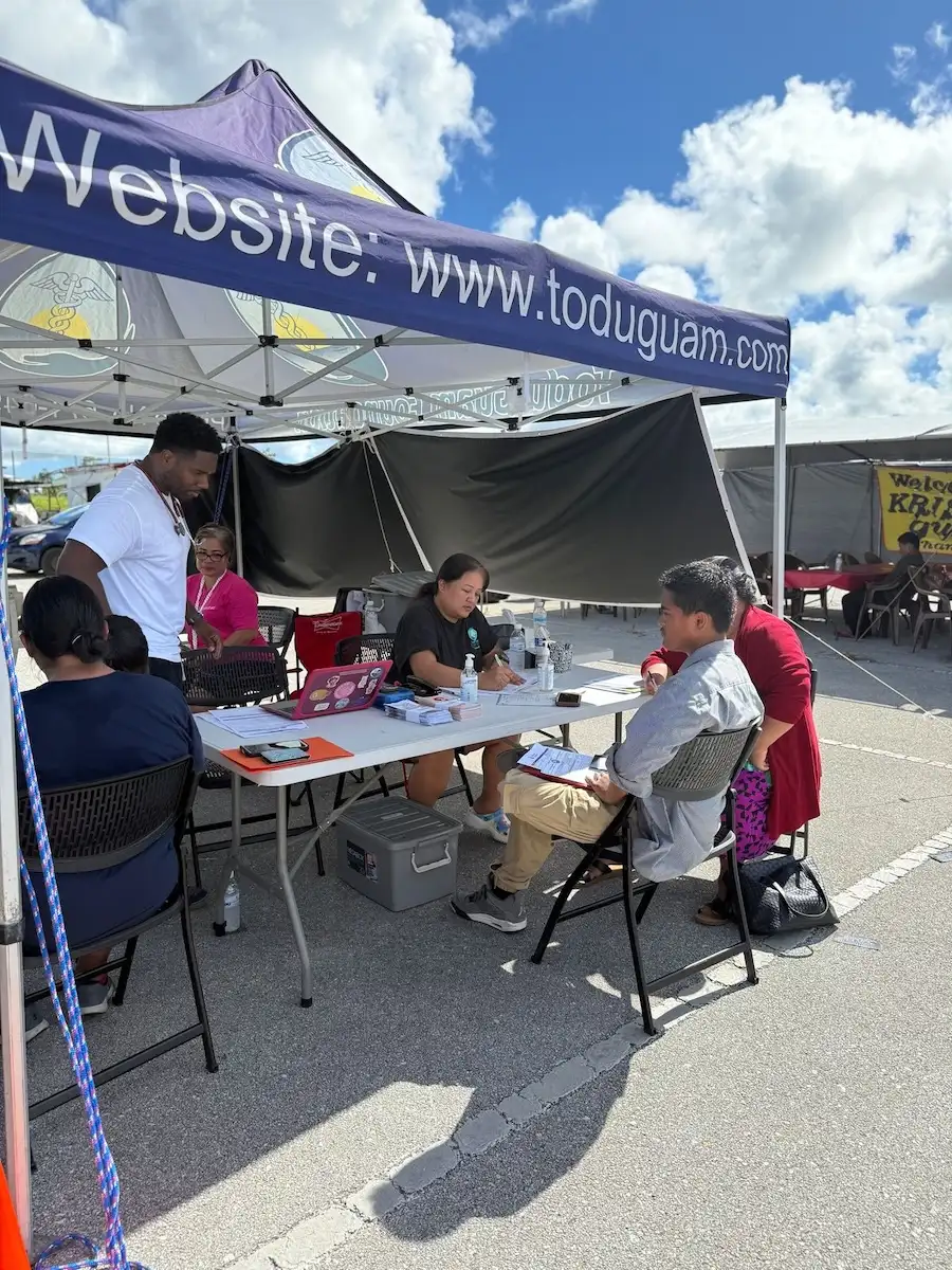 Todu Guam Foundation staff assisting residents at a healthcare outreach tent at Dededo Flea Market